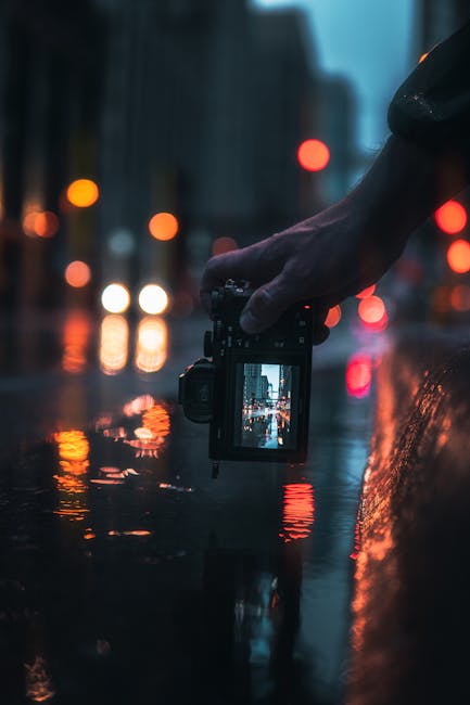 Capturing a moody night scene in downtown Minneapolis with vibrant reflections.